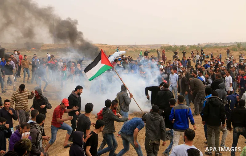 Palestinian protesters burn tires during clashes with Israeli security forces at tents protest at the Israel-Gaza border where Palestinians demand the right to return to their homeland, at the Israel-Gaza border, in Bure...