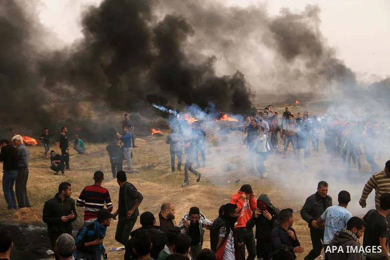 Palestinian protesters burn tires during clashes with Israeli security forces at tents protest at the Israel-Gaza border where Palestinians demand the right to return to their homeland, at the Israel-Gaza border, in Bure...