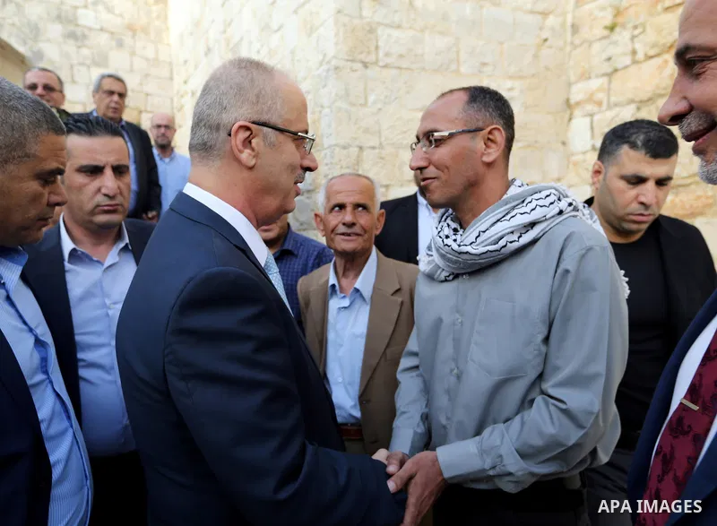 Palestinian Prime Minister Rami Hamdallah visits the Palestinian freed prisoner Suhaib Jbaiti, in the West Bank city of Tulkarem, on April 20, 2018. Photo by Prime Minister Office