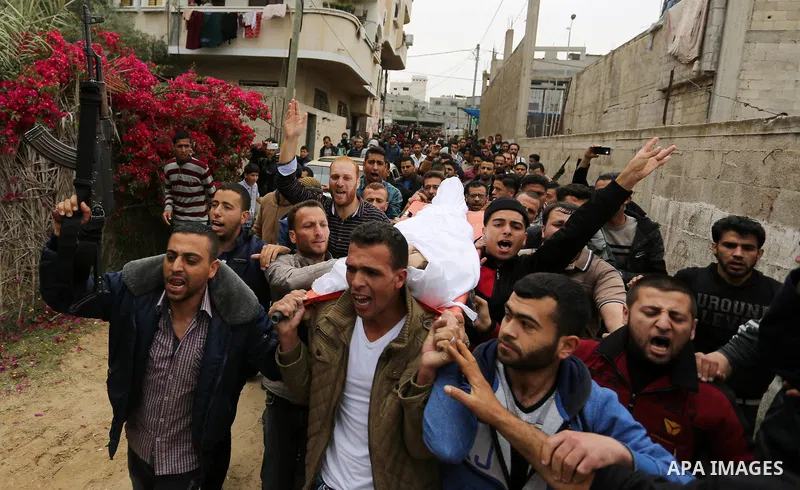 Palestinians carry the body of 29-year-old Saadi Abu Taha, who was killed at the Israel-Gaza border during clashes with Israeli security forces, during his funeral in Khan Yunis in the southern Gaza strip on April 21, 20...
