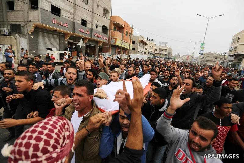 Palestinians carry the body of 29-year-old Saadi Abu Taha, who was killed at the Israel-Gaza border during clashes with Israeli security forces, during his funeral in Khan Yunis in the southern Gaza strip on April 21, 20...