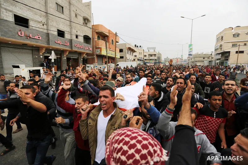 Palestinians carry the body of 29-year-old Saadi Abu Taha, who was killed at the Israel-Gaza border during clashes with Israeli security forces, during his funeral in Khan Yunis in the southern Gaza strip on April 21, 20...