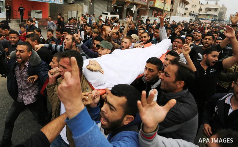 Palestinians carry the body of 29-year-old Saadi Abu Taha, who was killed at the Israel-Gaza border during clashes with Israeli security forces, during his funeral in Khan Yunis in the southern Gaza strip on April 21, 20...