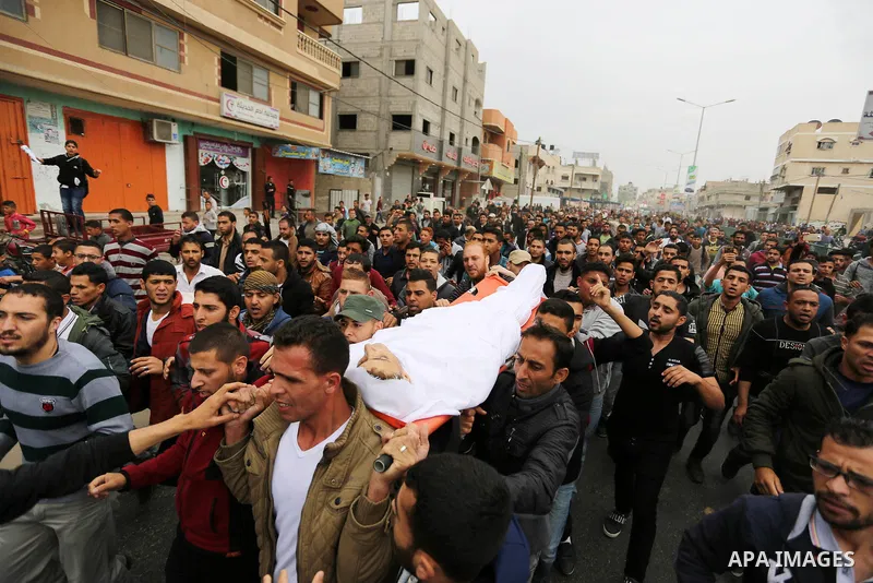 Palestinians carry the body of 29-year-old Saadi Abu Taha, who was killed at the Israel-Gaza border during clashes with Israeli security forces, during his funeral in Khan Yunis in the southern Gaza strip on April 21, 20...