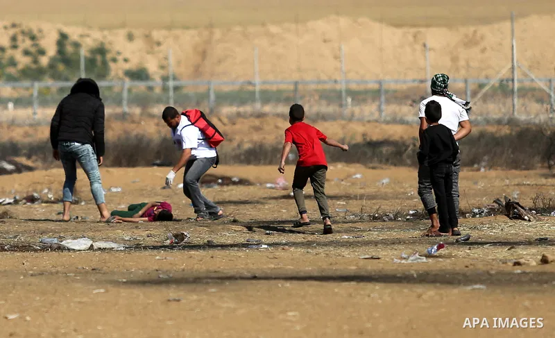 A wounded Palestinian boy is evacuated during clashes with Israeli security forces near the border fence with Israel near the southern Gaza Strip town of Khan Yunis during ongoing demonstrations on the Gaza-Israel border...