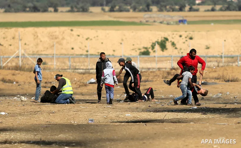 A wounded Palestinian boy is evacuated during clashes with Israeli security forces near the border fence with Israel near the southern Gaza Strip town of Khan Yunis during ongoing demonstrations on the Gaza-Israel border...