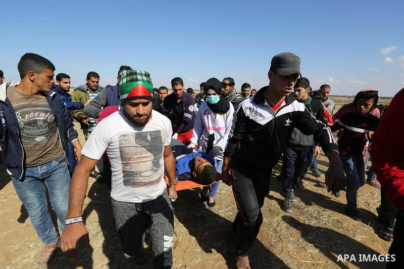 A wounded Palestinian protester is evacuated during clashes with Israeli security forces near the border fence with Israel near the southern Gaza Strip town of Khan Yunis during ongoing demonstrations on the Gaza-Israel...