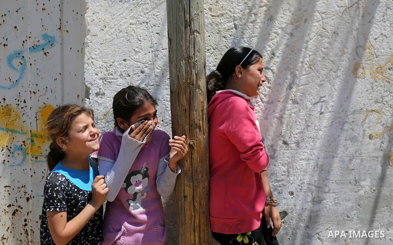 Palestinian children mourn during the funeral of a Palestinian deaf Tahreer Wahba, 18, who was died of from his injuries after being shot in the head by Israeli security forces during clashes on April 6, during his funer...