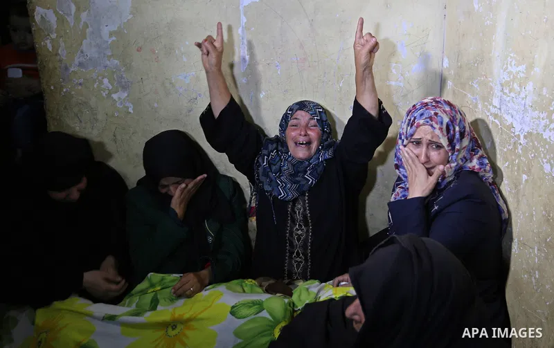 Relatives of a Palestinian deaf Tahreer Wahba, 18, who was died from his injuries after being shot in the head by Israeli security forces during clashes on April 6, mourn over his body during his funeral in Khan Yunis, i...