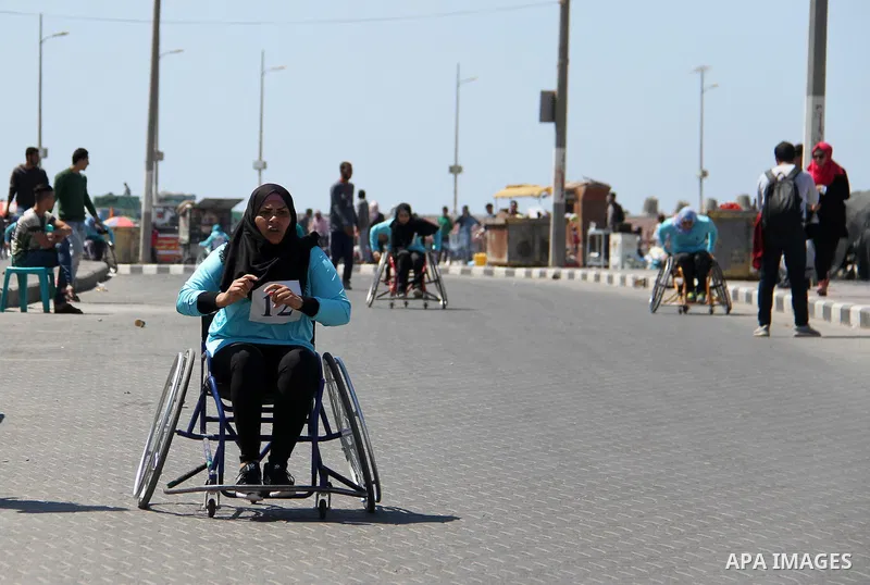 Disabled Palestinian women take part in world education week marathon in Gaza seaport, on April 23, 2018 in Gaza city. Photo by Mahmoud Ajour