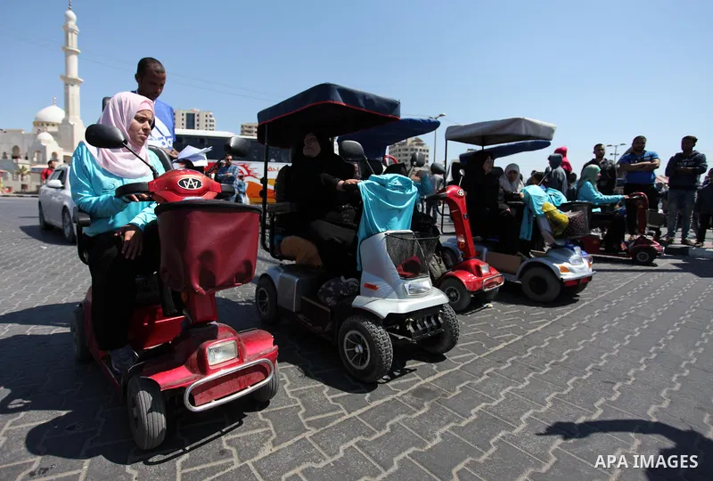 Disabled Palestinian women take part in world education week marathon in Gaza seaport, on April 23, 2018 in Gaza city. Photo by Mahmoud Ajour