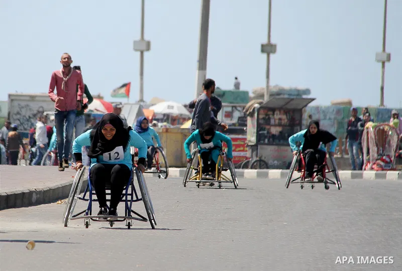 Disabled Palestinian women take part in world education week marathon in Gaza seaport, on April 23, 2018 in Gaza city. Photo by Mahmoud Ajour