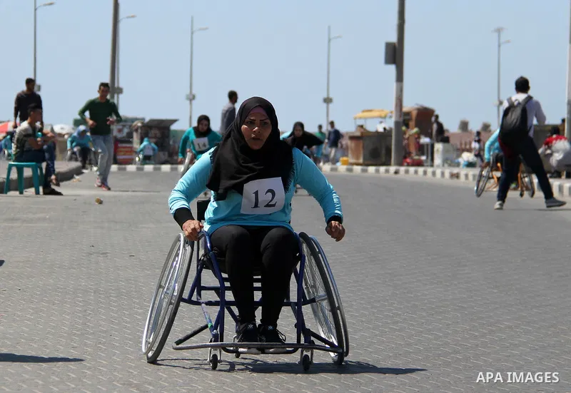 Disabled Palestinian women take part in world education week marathon in Gaza seaport, on April 23, 2018 in Gaza city. Photo by Mahmoud Ajour