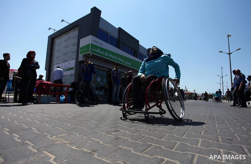 Disabled Palestinian women take part in world education week marathon in Gaza seaport, on April 23, 2018 in Gaza city. Photo by Mahmoud Ajour