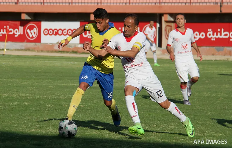 Palestinian players of Shabab Jabalia club "yellow" and players of Shabab Khan Younis club "white" compete during a football match of semi final Gaza Cup, at Palestine stadium, in Gaza city on April 23, 2018. Photo by Ma...