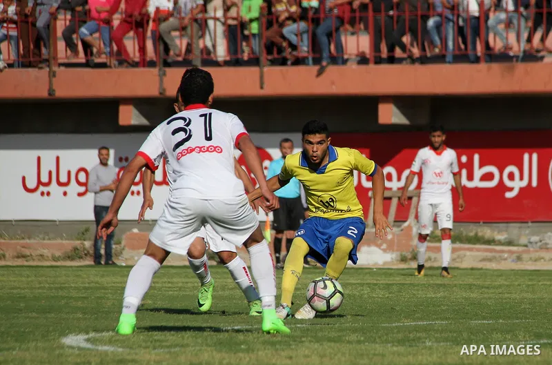 Palestinian players of Shabab Jabalia club "yellow" and players of Shabab Khan Younis club "white" compete during a football match of semi final Gaza Cup, at Palestine stadium, in Gaza city on April 23, 2018. Photo by Ma...