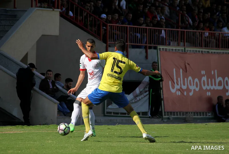 Palestinian players of Shabab Jabalia club "yellow" and players of Shabab Khan Younis club "white" compete during a football match of semi final Gaza Cup, at Palestine stadium, in Gaza city on April 23, 2018. Photo by Ma...