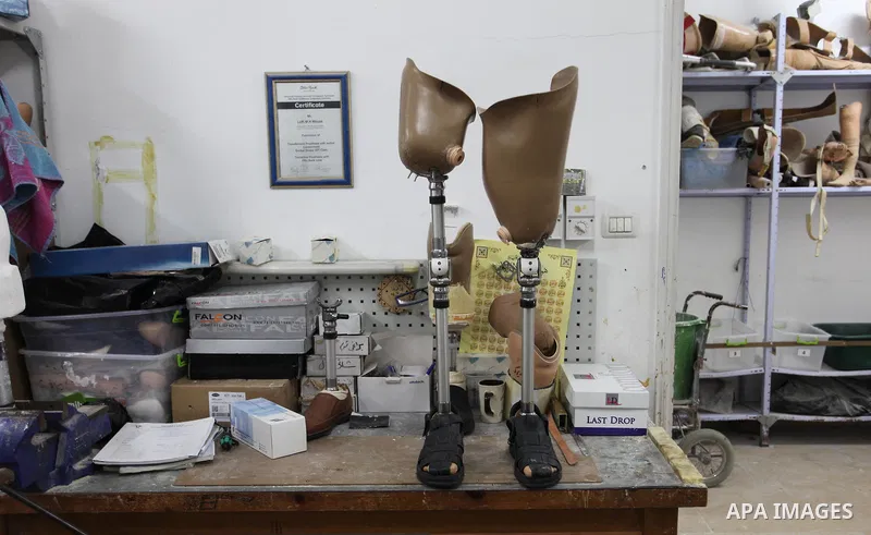 A Palestinian staff member prepares a prosthetic leg at Gaza's Artificial Limbs and Polio Center (ALPC) in Gaza City on April 24, 2018. According to Gaza health ministry, 17 Palestinians had limbs amputated during clashe...