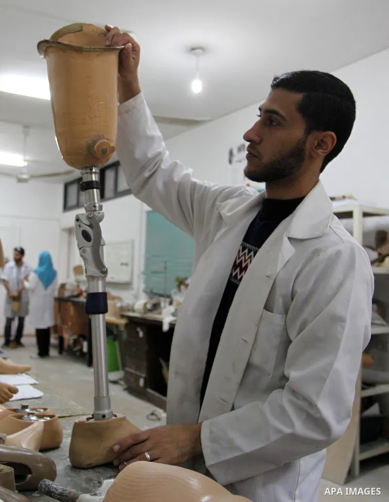 A Palestinian staff member prepares a prosthetic leg at Gaza's Artificial Limbs and Polio Center (ALPC) in Gaza City on April 24, 2018. According to Gaza health ministry, 17 Palestinians had limbs amputated during clashe...