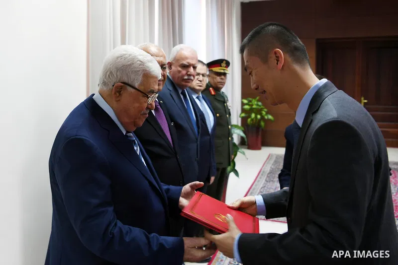 Palestinian President Mahmoud Abbas accepts the credentials of the ambassador of the Republic of China to the State of Palestine, in the West Bank city of Ramallah, on April 24, 2018. Photo by Thaer Ganaim