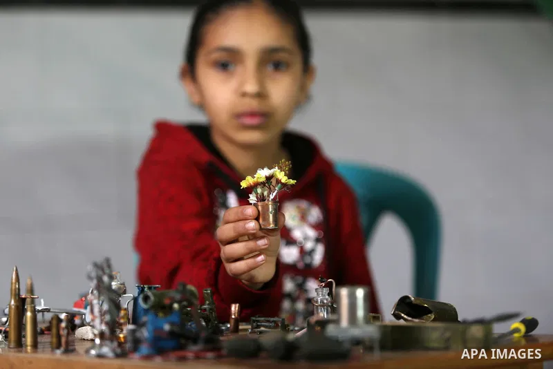 Palestinian artist Magdy Abu Takeya, 38, converts gunshots used by the Israeli security forces against Palestinian protesters to small pieces of art knows as "Art of thumbnails" at his house in Nuseirat in the central Ga...