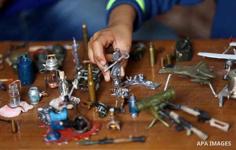 Palestinian artist Magdy Abu Takeya, 38, converts gunshots used by the Israeli security forces against Palestinian protesters to small pieces of art knows as "Art of thumbnails" at his house in Nuseirat in the central Ga...