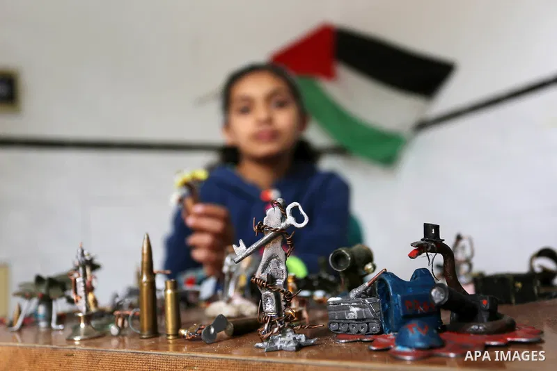 Palestinian artist Magdy Abu Takeya, 38, converts gunshots used by the Israeli security forces against Palestinian protesters to small pieces of art knows as "Art of thumbnails" at his house in Nuseirat in the central Ga...