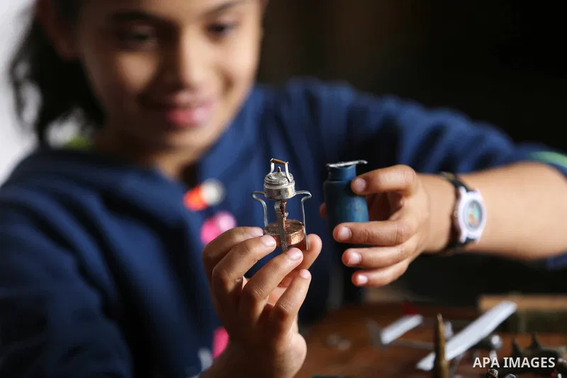 Palestinian artist Magdy Abu Takeya, 38, converts gunshots used by the Israeli security forces against Palestinian protesters to small pieces of art knows as "Art of thumbnails" at his house in Nuseirat in the central Ga...