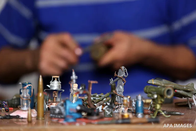 Palestinian artist Magdy Abu Takeya, 38, converts gunshots used by the Israeli security forces against Palestinian protesters to small pieces of art knows as "Art of thumbnails" at his house in Nuseirat in the central Ga...