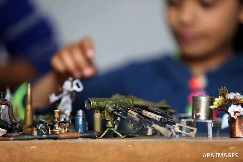 Palestinian artist Magdy Abu Takeya, 38, converts gunshots used by the Israeli security forces against Palestinian protesters to small pieces of art knows as "Art of thumbnails" at his house in Nuseirat in the central Ga...