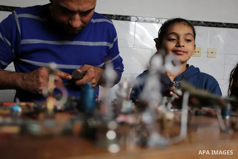 Palestinian artist Magdy Abu Takeya, 38, converts gunshots used by the Israeli security forces against Palestinian protesters to small pieces of art knows as "Art of thumbnails" at his house in Nuseirat in the central Ga...