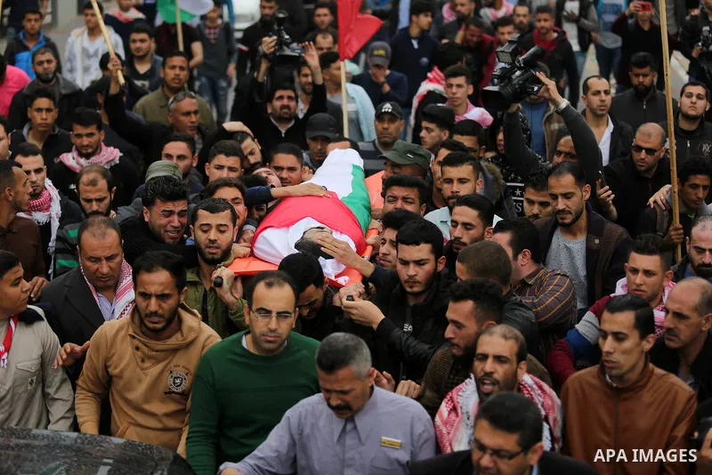 Mourners carry the body of Palestinian journalist Ahmed Abu Hussein, 24, who was died of his injuries sustained by Israeli security forces as he was covering demonstrations on the Gaza border since two weeks ago, during...