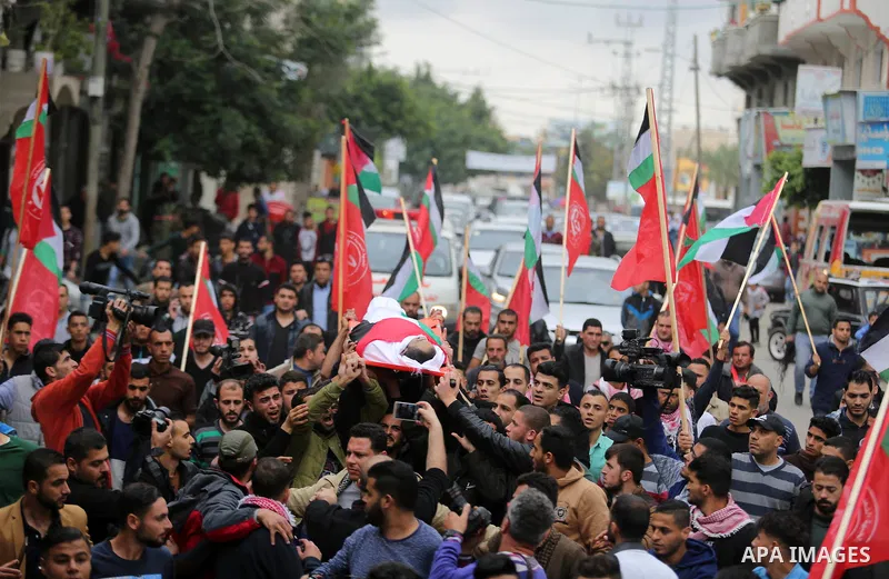 Mourners carry the body of Palestinian journalist Ahmed Abu Hussein, 24, who was died of his injuries sustained by Israeli security forces as he was covering demonstrations on the Gaza border since two weeks ago, during...