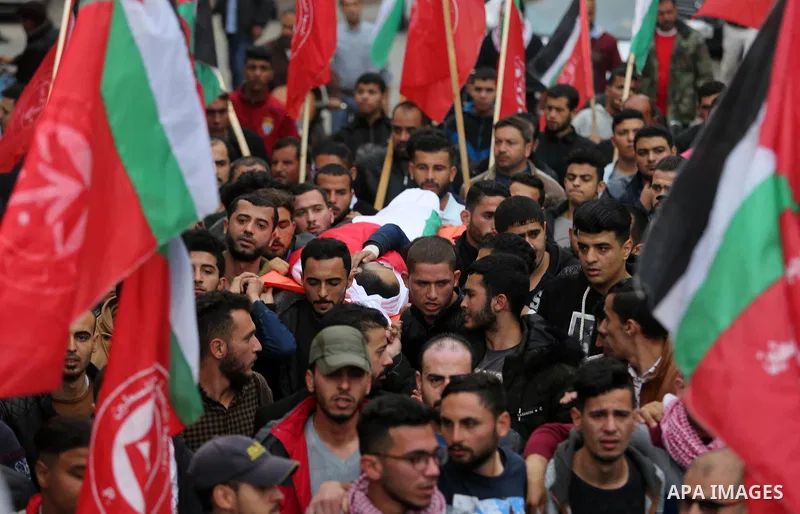 Mourners carry the body of Palestinian journalist Ahmed Abu Hussein, 24, who was died of his injuries sustained by Israeli security forces as he was covering demonstrations on the Gaza border since two weeks ago, during...