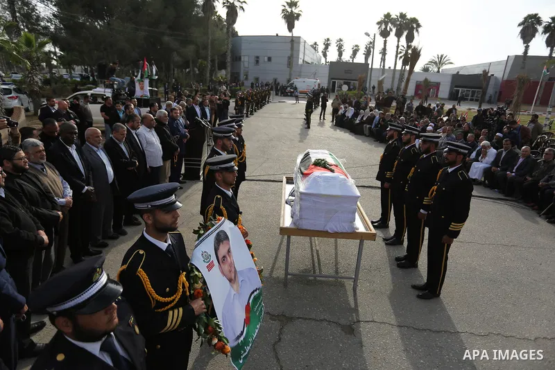 Members of the Palestinian Hamas security forces stand next to the coffin containing the body of Palestinian scientist Fadi al-Batsh, assassinated in Malaysia, in the Rafah border crossing in the southern Gaza Strip on A...