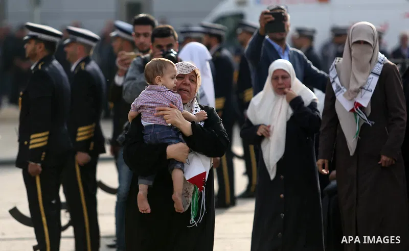 The son of Palestinian scientist Fadi al-Batsh, who was assassinated in Malaysia, is held by his grandmother as his father's body arrives at the Rafah border crossing in the southern Gaza Strip on April 26, 2018, after h...