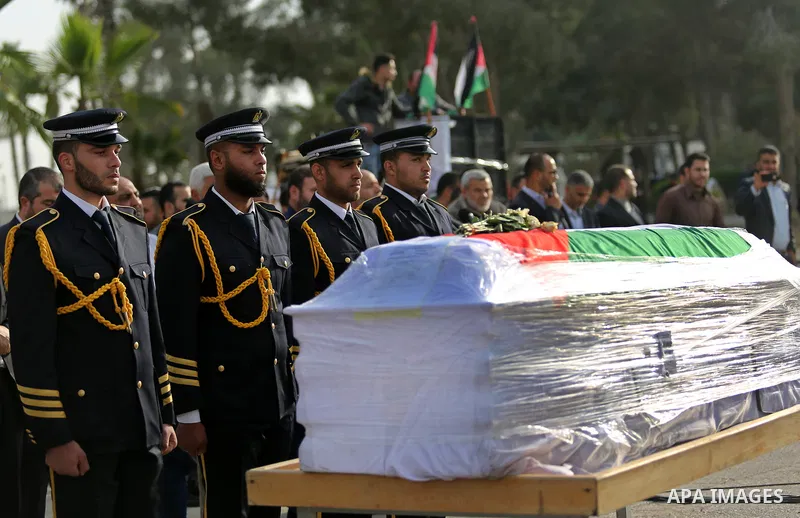 Members of the Palestinian Hamas security forces stand next to the coffin containing the body of Palestinian scientist Fadi al-Batsh, assassinated in Malaysia, in the Rafah border crossing in the southern Gaza Strip on A...