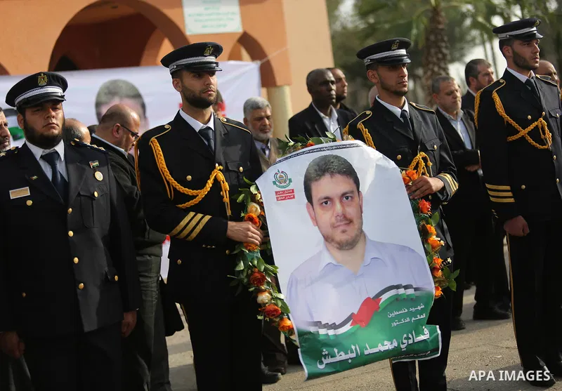Members of the Palestinian Hamas security forces stand next to the coffin containing the body of Palestinian scientist Fadi al-Batsh, assassinated in Malaysia, in the Rafah border crossing in the southern Gaza Strip on A...