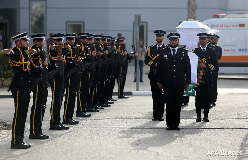 Members of the Palestinian Hamas security forces stand next to the coffin containing the body of Palestinian scientist Fadi al-Batsh, assassinated in Malaysia, in the Rafah border crossing in the southern Gaza Strip on A...