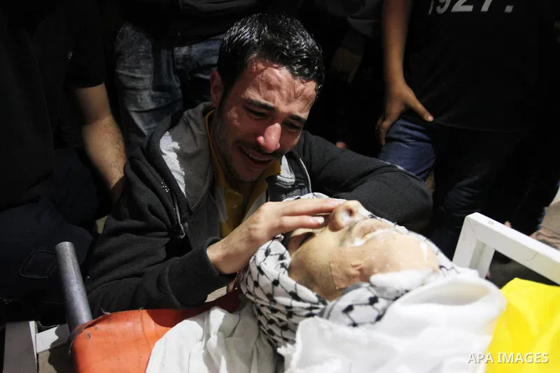 Relatives of Palestinian Khalil Atallah, 25, who was shot dead by Israeli security forces during clashes at the Israel-Gaza border, mourn over his body during his funeral in Gaza city, on April 28, 2018. Photo by Mahmoud...