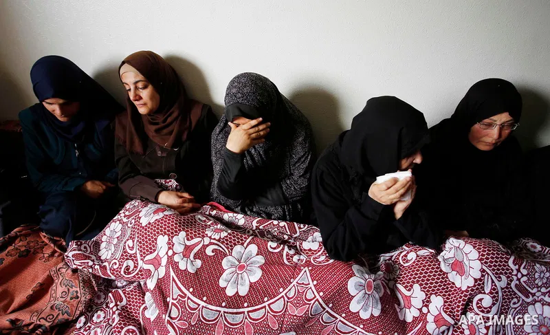 Palestinian women mourn during the funeral of 15-year-old Palestinian teenager Azzam Oweida who was died of his injuries sustained by Israeli security forces during clashes at the Israel-Gaza border, in Khan Yunis in the...