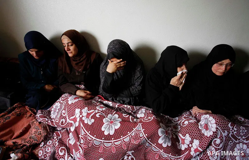 Palestinian women mourn during the funeral of 15-year-old Palestinian teenager Azzam Oweida who was died of his injuries sustained by Israeli security forces during clashes at the Israel-Gaza border, in Khan Yunis in the...