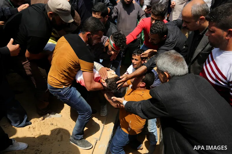 Mourners bury the body of 15-year-old Palestinian teenager Azzam Oweida who was died of his injuries sustained by Israeli security forces during clashes at the Israel-Gaza border, during his funeral in Khan Yunis in the...