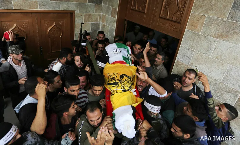 Mourners carry the body of Abdul Salam Bakr, 29, who was shot dead by Israeli security forces during clashes at the Israel-Gaza border, during his funeral in Khan Yunis in the southern Gaza Strip on April 28, 2018. Photo...