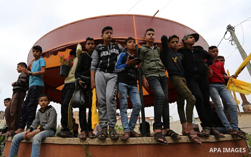 Palestinian boys attend the funeral of Abdul Salam Bakr, 29, who was shot dead by Israeli security forces during clashes at the Israel-Gaza border, in Khan Yunis in the southern Gaza Strip on April 28, 2018. Photo by Ash...
