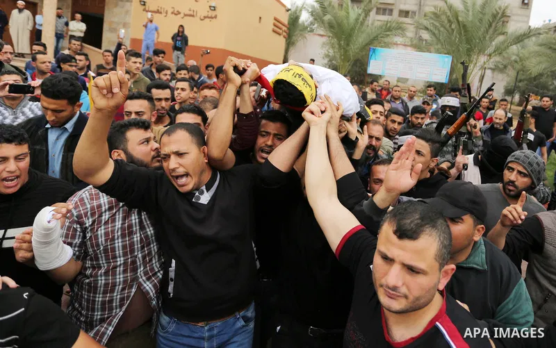 Mourners carry the body of Abdul Salam Bakr, 29, who was shot dead by Israeli security forces during clashes at the Israel-Gaza border, during his funeral in Khan Yunis in the southern Gaza Strip on April 28, 2018. Photo...