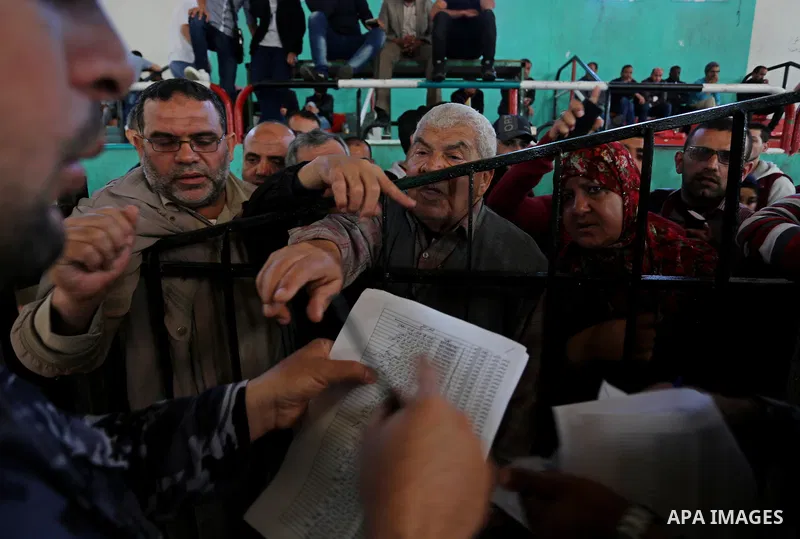 Palestinians wait for travel permits to cross into Egypt through the Rafah border crossing after it was opened by Egyptian authorities for humanitarian cases, in Khan Yunis in the southern Gaza Strip on April 29, 2018. P...