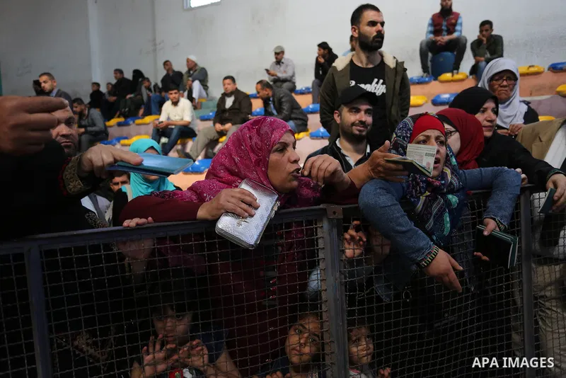 Palestinians wait for travel permits to cross into Egypt through the Rafah border crossing after it was opened by Egyptian authorities for humanitarian cases, in Khan Yunis in the southern Gaza Strip on April 29, 2018. P...