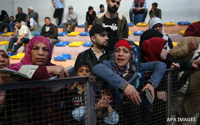 Palestinians wait for travel permits to cross into Egypt through the Rafah border crossing after it was opened by Egyptian authorities for humanitarian cases, in Khan Yunis in the southern Gaza Strip on April 29, 2018. P...