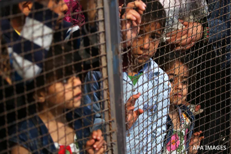 Palestinians wait for travel permits to cross into Egypt through the Rafah border crossing after it was opened by Egyptian authorities for humanitarian cases, in Khan Yunis in the southern Gaza Strip on April 29, 2018. P...